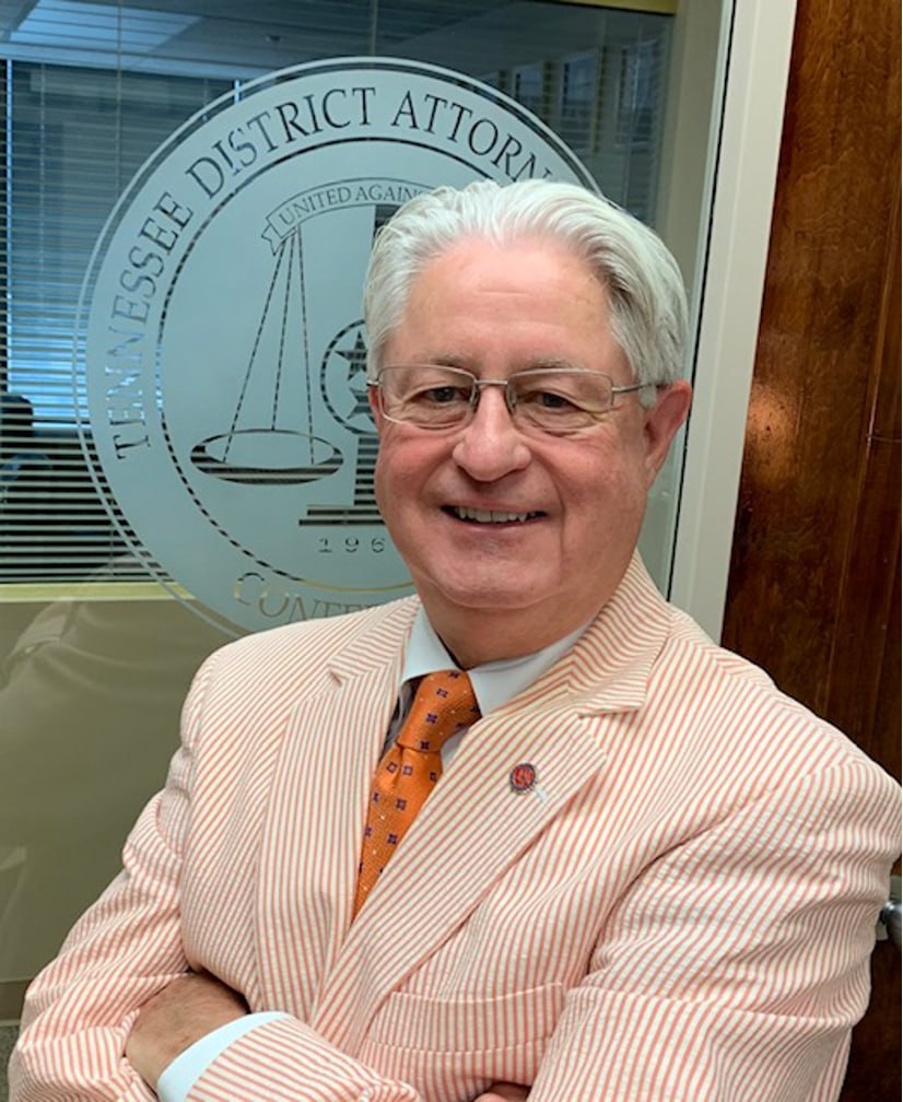 Jerry Estes in front of the Tennessee District Attorneys seal